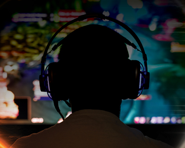 Person in front of a bright video game screen