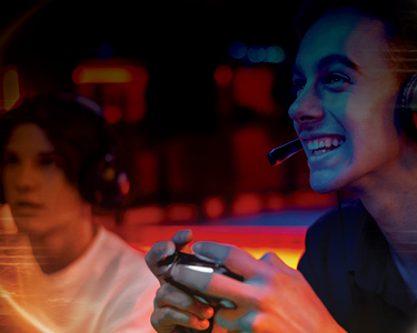 Two people laughing while playing a video game together