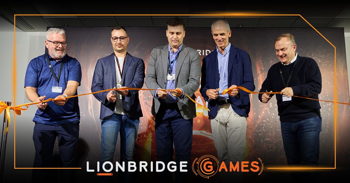 Lionbridge leadership cutting an orange ribbon