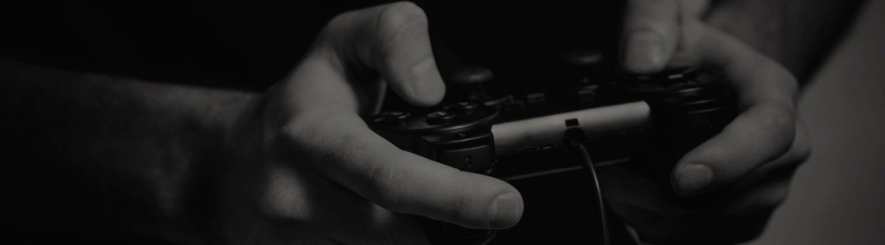 A close-up of a gamer's hands with a gamepad controller.