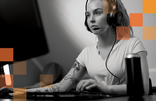 Trendy person with tattoos working on computer