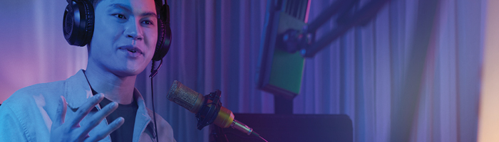 a video game voice actor in front of a microphone