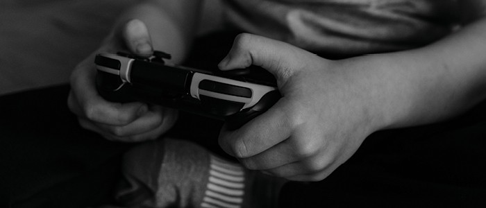 Hands hold a game controller.