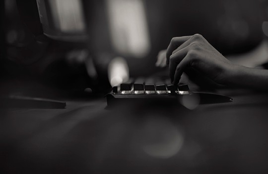 A close-up of hands at a keyboard.